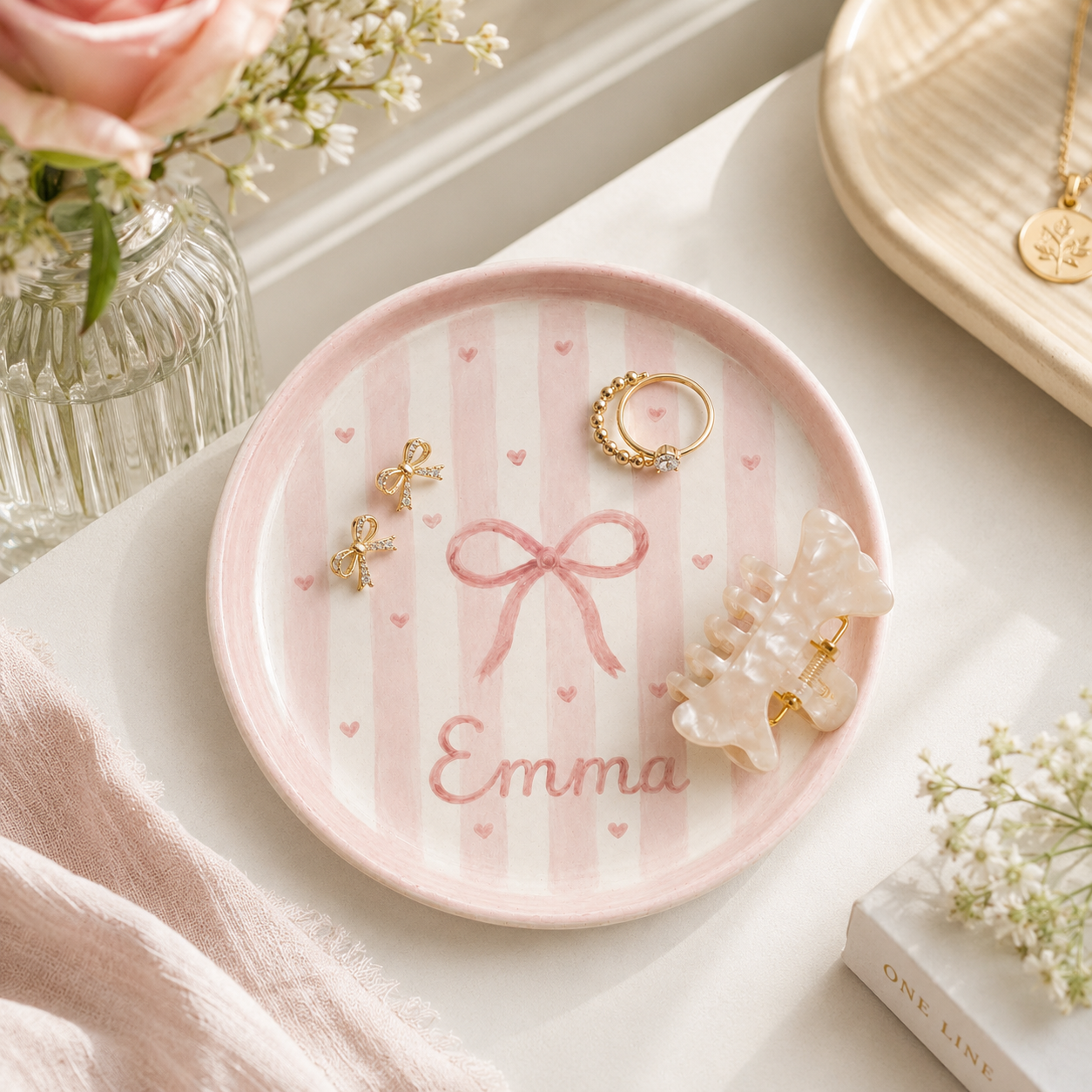Pink bow personalized ceramic trinket dish styled with jewelry and Emma name