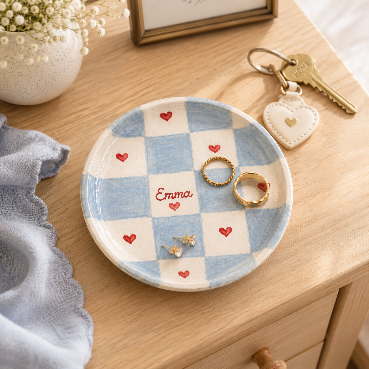 Blue checkered personalized ceramic trinket dish styled with rings and Emma name