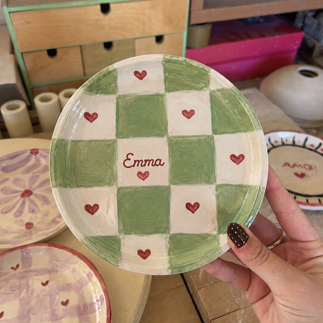 Green checkered ceramic trinket dish being hand painted with Emma name