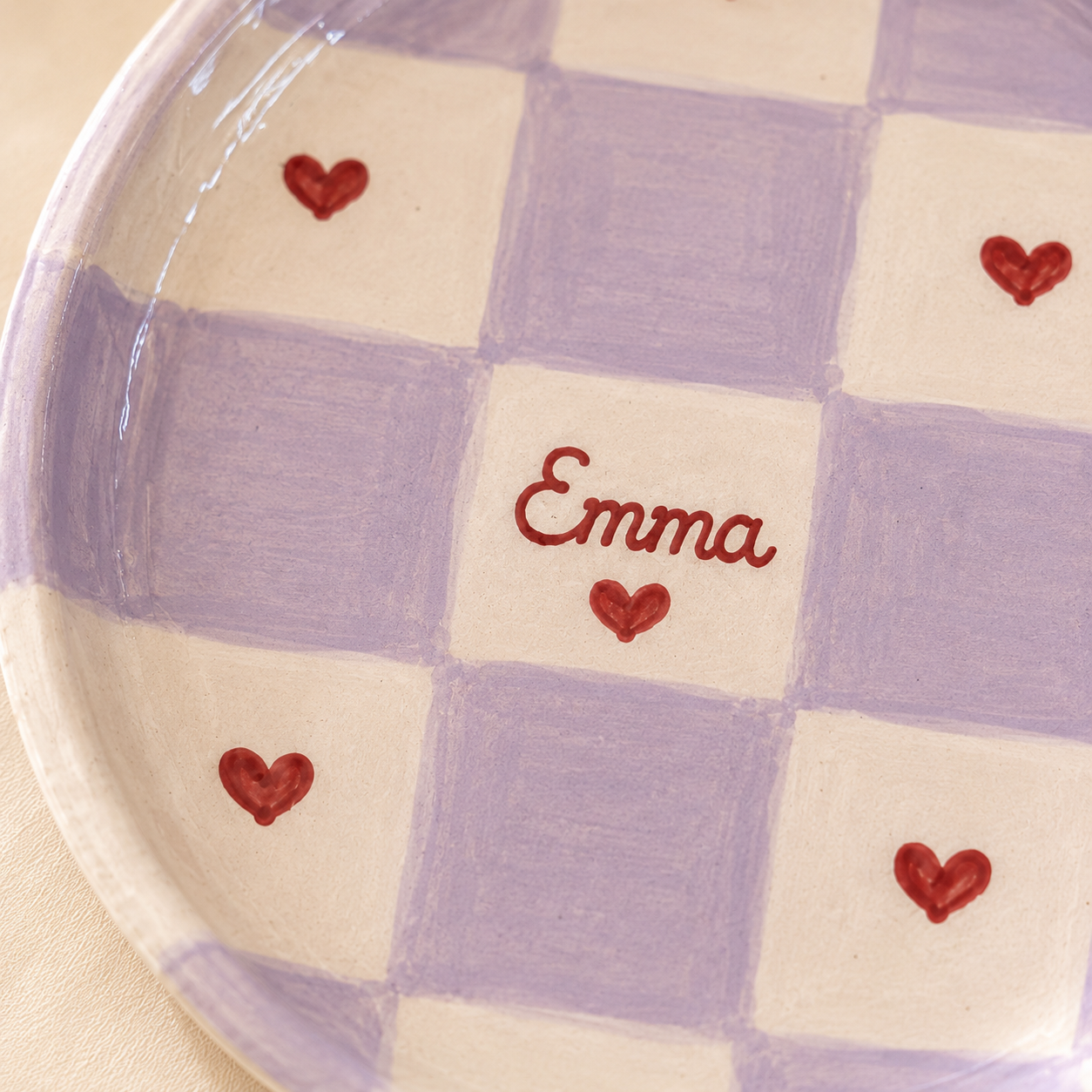 Close up of lavender checkered ceramic trinket dish with red hearts and Emma name