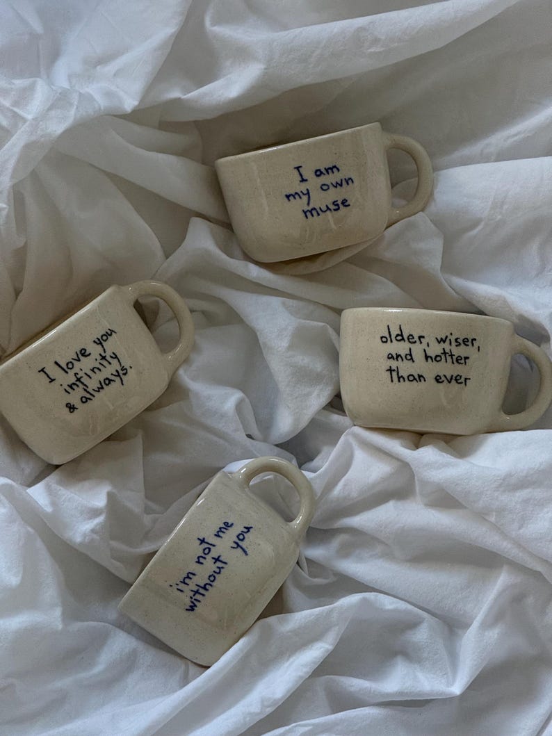 Personalized handwritten ceramic mugs on white fabric