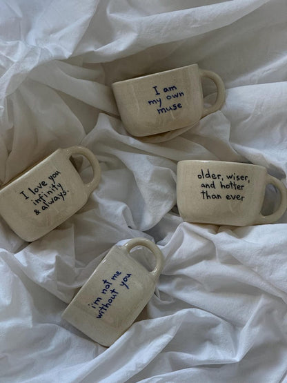 Personalized handwritten ceramic mugs on white fabric