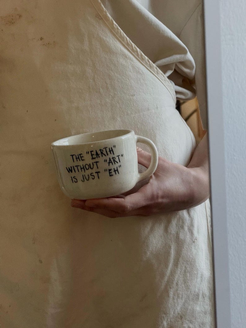 Personalized ceramic mug held in hand with quote text